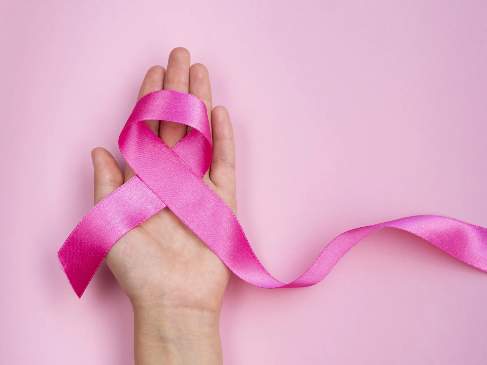 close-up-breast-cancer-concept-with-ribbon-scaled